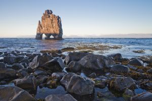 A big rock formation in the water in Húnafjörður⁩, Iceland