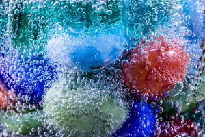 Marbles in a glass of fizzy water