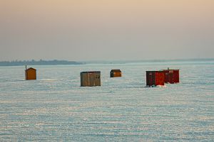 Some ice fishing huts on frozen Lake Couchiching near Orillia, Ontario, Canada